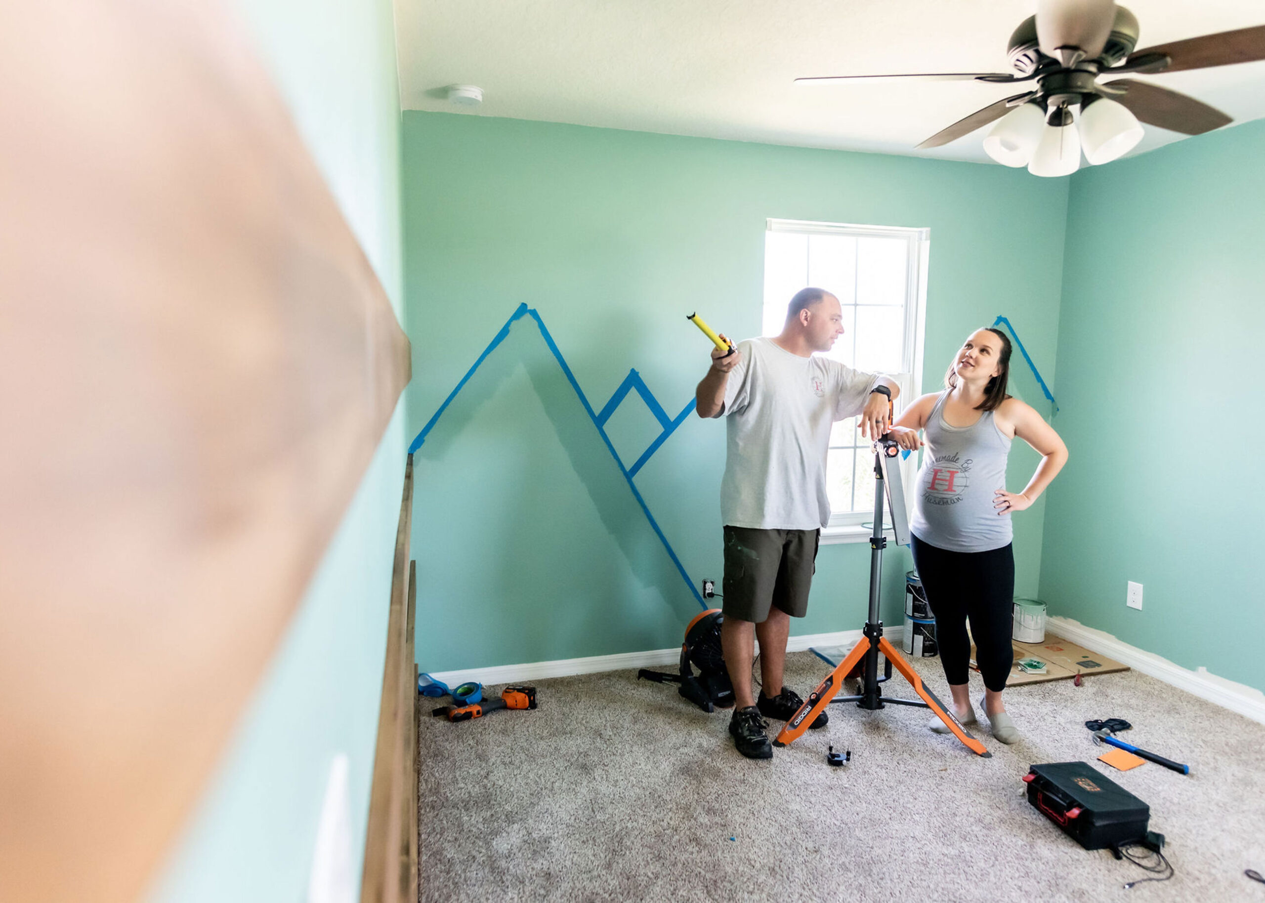 couple discussing nursery accent wall