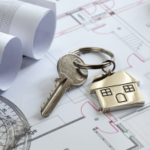 house key with home key chain and floorplans