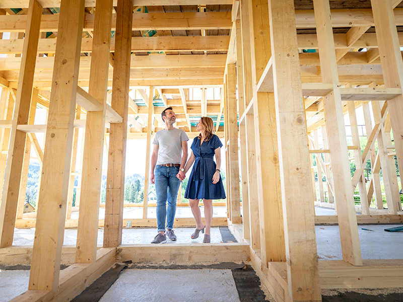 Couple walking through framed ADU construction